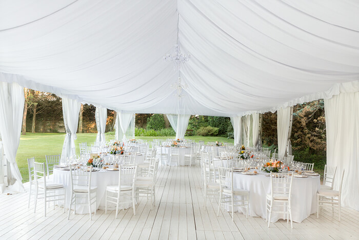 Elegant white event tent setup for a wedding or formal celebration